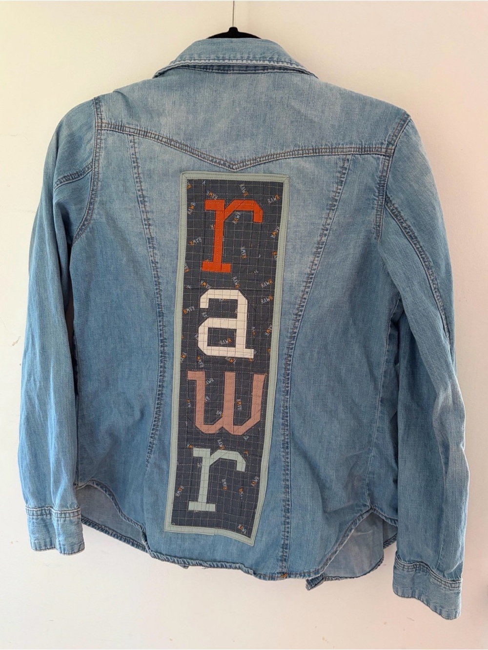 Upcycled women’s Jean shirt with patchwork Rawr on the back